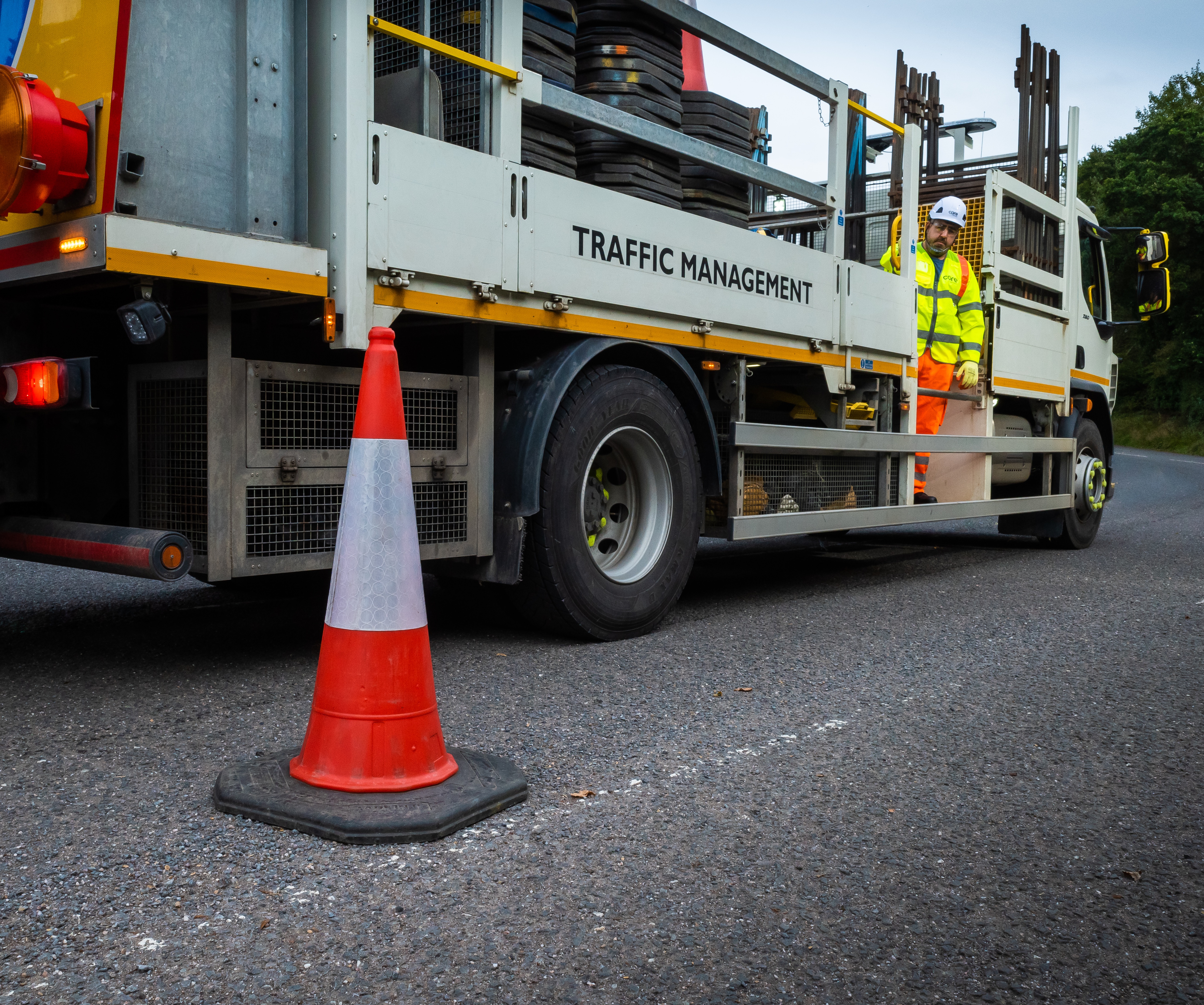 High visibility worker laying traffic cones